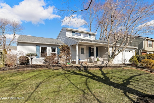 traditional home featuring a front yard, covered porch, and a garage