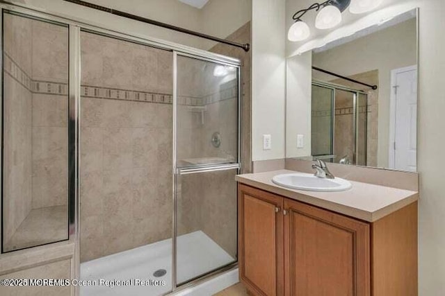 full bath featuring vanity and a stall shower