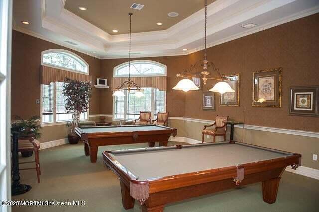 game room featuring visible vents, a tray ceiling, ornamental molding, plenty of natural light, and billiards