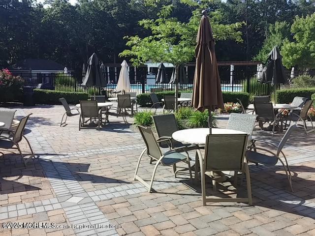 view of patio featuring outdoor dining area and fence