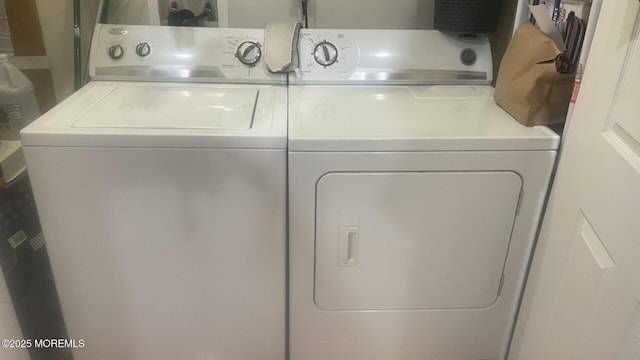 washroom featuring washer and clothes dryer and laundry area