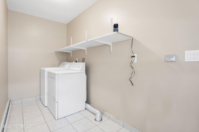 laundry room featuring baseboards, laundry area, light tile patterned flooring, washing machine and dryer, and baseboard heating