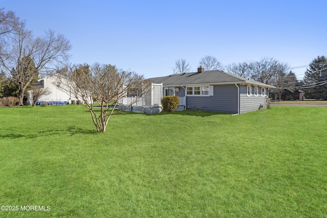 exterior space featuring a front yard and a chimney