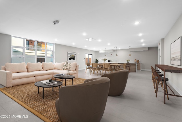 living room featuring recessed lighting and baseboards