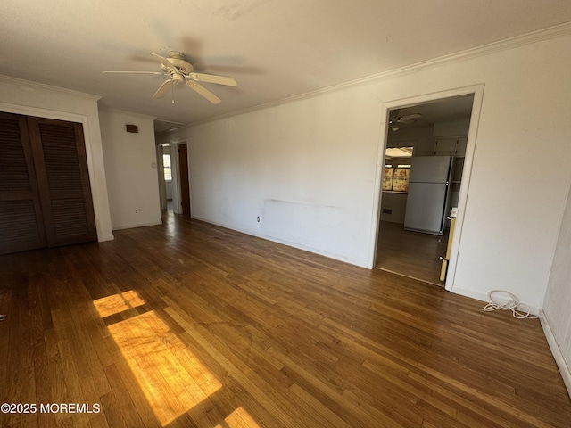 unfurnished bedroom featuring ornamental molding, a ceiling fan, wood finished floors, freestanding refrigerator, and a closet