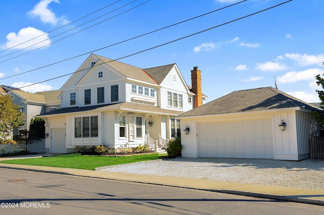 view of front of property featuring a garage, board and batten siding, an outdoor structure, and driveway