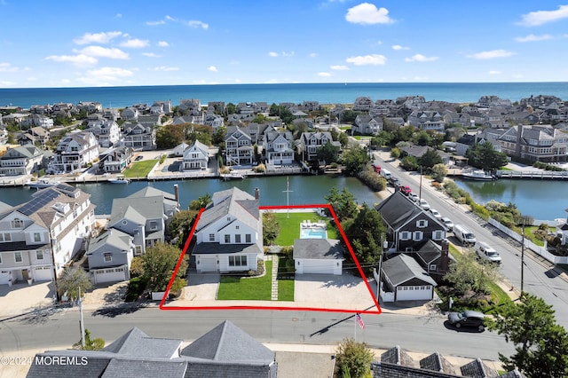 bird's eye view with a residential view and a water view