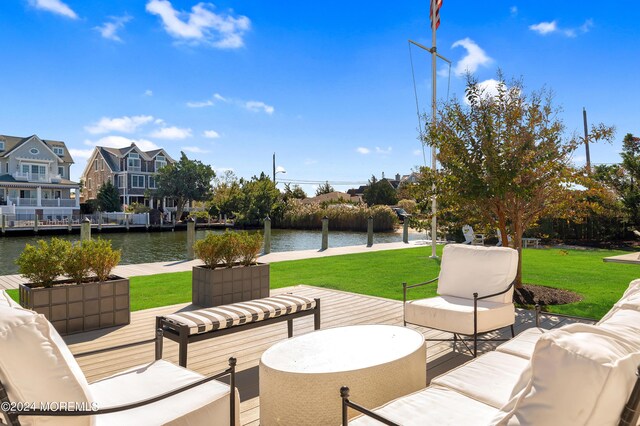 view of patio / terrace with outdoor lounge area and a deck with water view