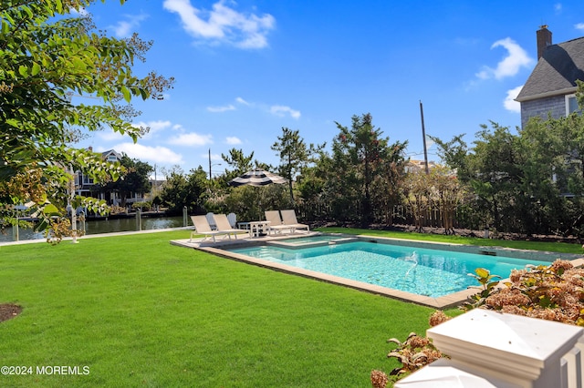 view of pool with a patio, a yard, a water view, and a pool with connected hot tub