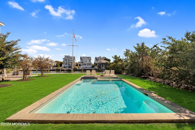 view of swimming pool featuring a yard, a patio area, and a pool with connected hot tub