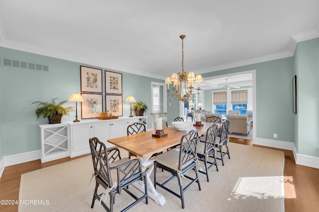 dining area with visible vents, ornamental molding, baseboards, and wood finished floors