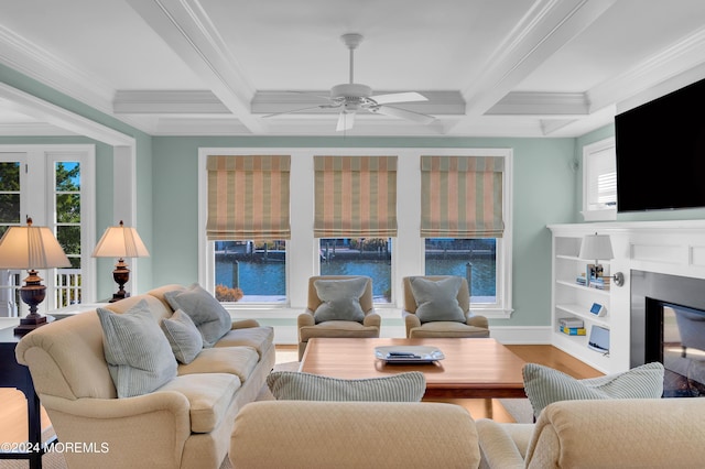 living room with beam ceiling, coffered ceiling, wood finished floors, a healthy amount of sunlight, and ceiling fan