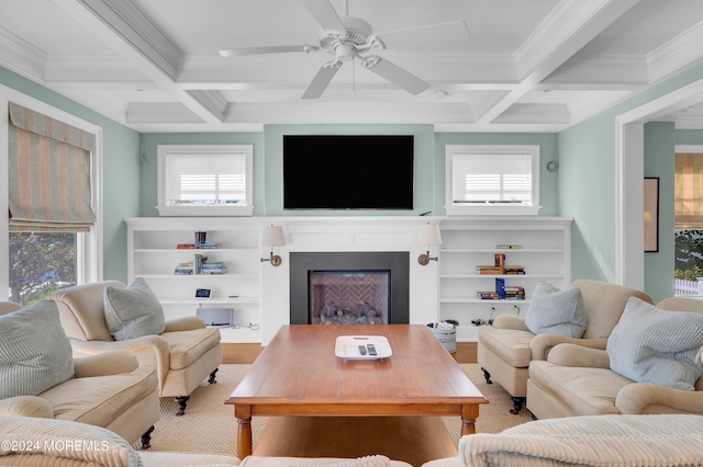 living area featuring beam ceiling, a fireplace, coffered ceiling, and ceiling fan