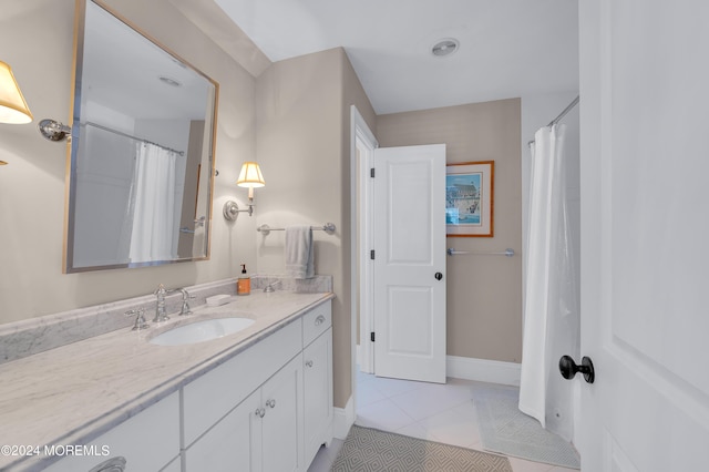 bathroom featuring tile patterned flooring, vanity, and baseboards