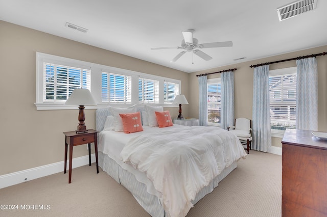 bedroom featuring light colored carpet, baseboards, and visible vents