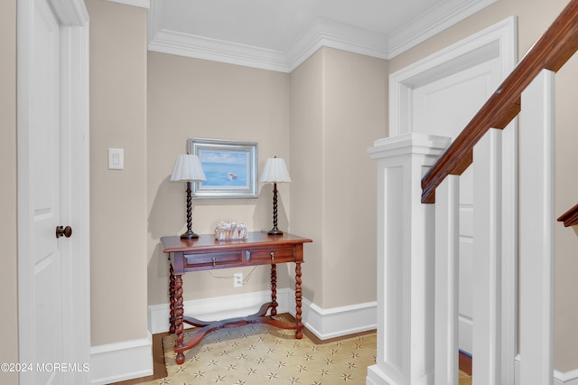 interior space featuring baseboards and ornamental molding