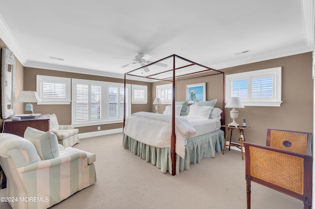 carpeted bedroom with visible vents, a ceiling fan, baseboards, and ornamental molding