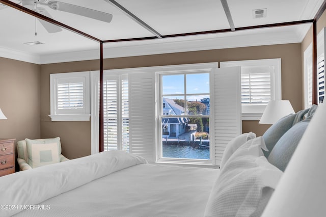 bedroom with ceiling fan, visible vents, and ornamental molding