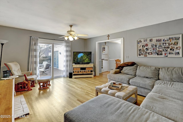 living room with ceiling fan and wood finished floors