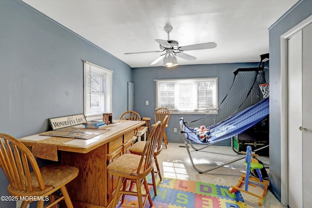 carpeted dining space with ceiling fan