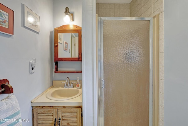 bathroom with a stall shower and vanity