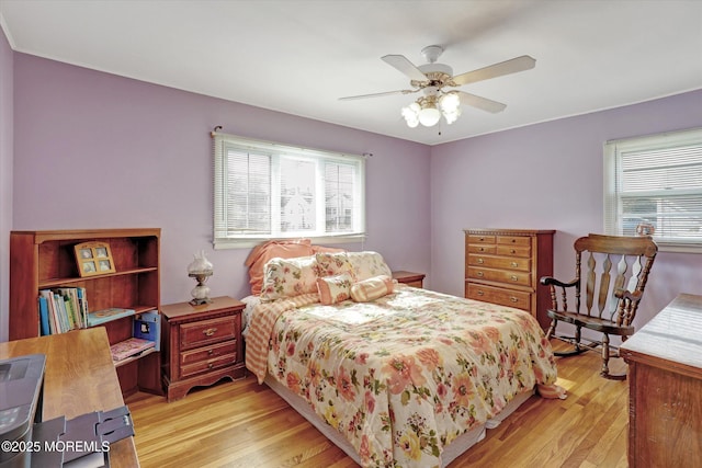 bedroom featuring light wood-style flooring and a ceiling fan