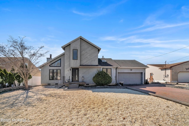 view of front of property featuring decorative driveway, fence, a garage, and crawl space