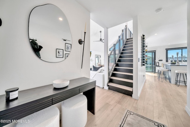 stairs with recessed lighting and wood finished floors