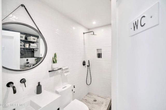 bathroom featuring vanity, toilet, and a shower stall