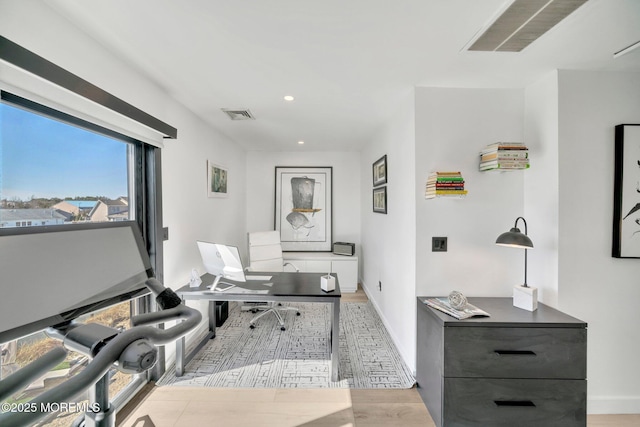 office space with recessed lighting, visible vents, baseboards, and wood finished floors