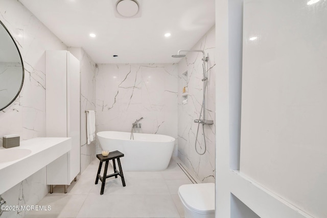 bathroom featuring a freestanding tub, a marble finish shower, toilet, and recessed lighting