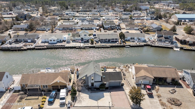 drone / aerial view featuring a residential view and a water view