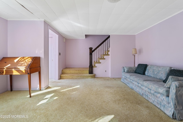 living room featuring stairs, carpet flooring, baseboards, and ornamental molding