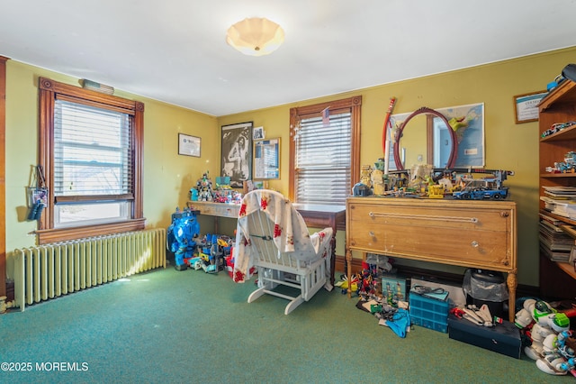 interior space with carpet flooring, multiple windows, and radiator