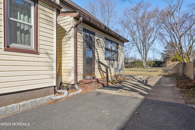 view of side of home featuring fence