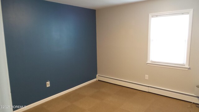 spare room featuring baseboards and baseboard heating