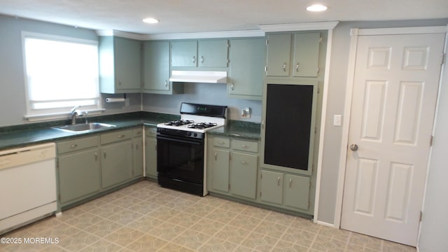 kitchen with dark countertops, under cabinet range hood, gas range, dishwasher, and a sink