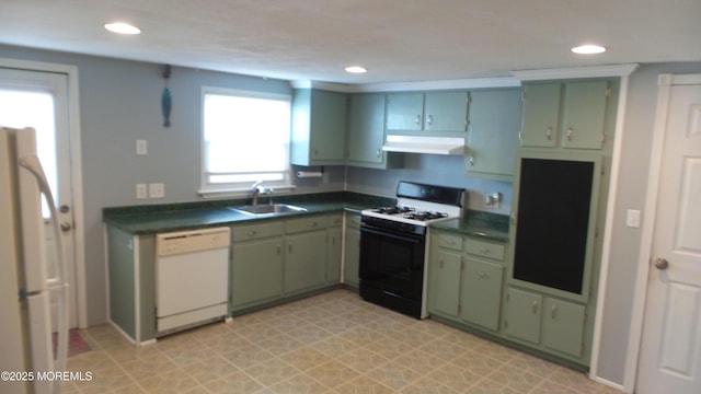 kitchen featuring white appliances, under cabinet range hood, green cabinetry, and a sink