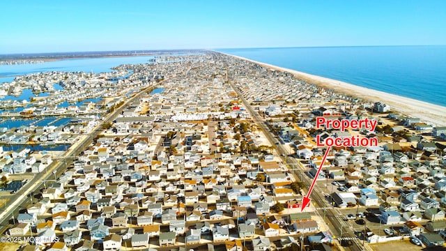 drone / aerial view with a view of the beach and a water view