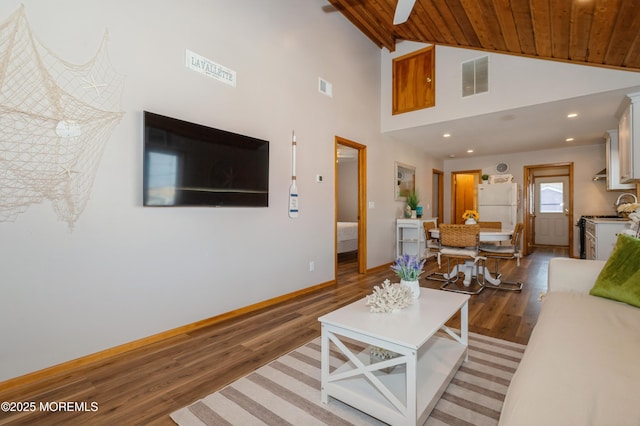 living area featuring visible vents, baseboards, light wood-type flooring, and lofted ceiling