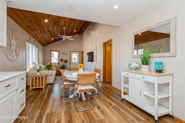 dining space with recessed lighting, light wood-type flooring, wooden ceiling, and vaulted ceiling