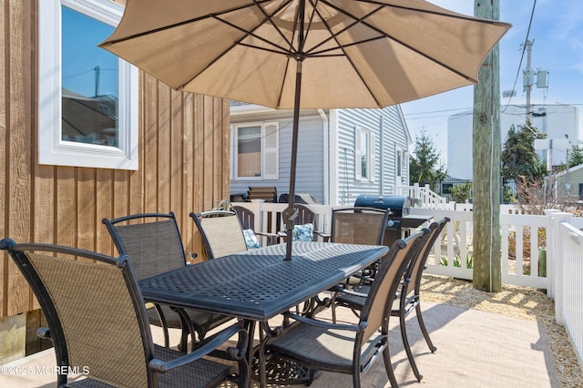 view of patio with outdoor dining space and fence