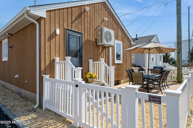 view of front facade with ac unit, crawl space, and fence