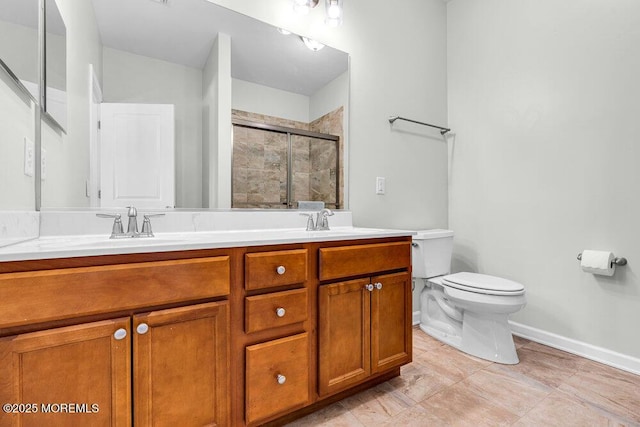 bathroom with a sink, a shower stall, toilet, and double vanity