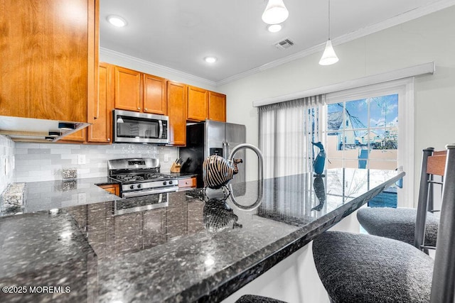 kitchen featuring visible vents, backsplash, stainless steel appliances, brown cabinetry, and crown molding