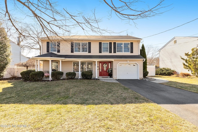 view of front of house featuring a garage, a front yard, driveway, and fence