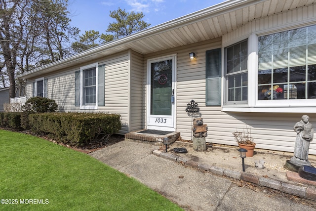 doorway to property featuring a yard