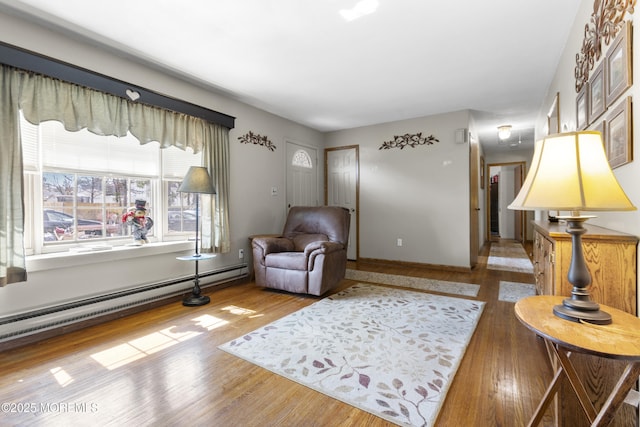 interior space with wood finished floors and baseboard heating