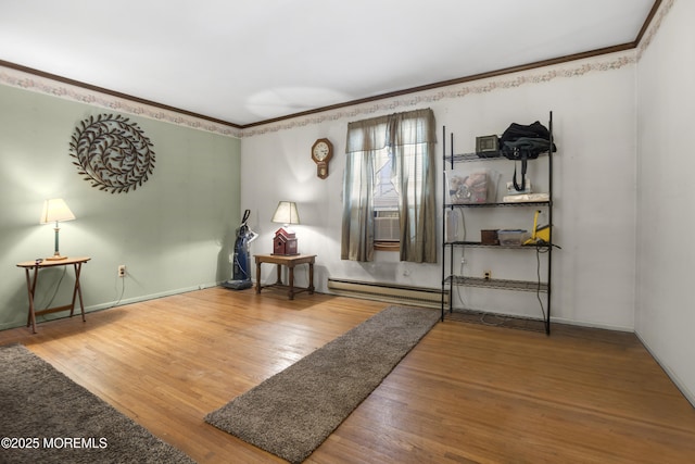 interior space featuring crown molding, wood finished floors, baseboards, and baseboard heating