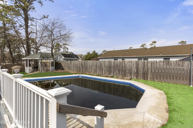 view of pool with a gazebo, a fenced backyard, and a fenced in pool